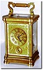 C.1885, French, Brass Cased Carriage Clock, a stylized Angle Riche case with a gorge style bottom, all 4 sides slightly convex, and with a wonderful floral mask over the gilded dial.