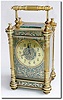C.1900, French, Brass Cased Carriage Clock, in a fluted column case with a chased and gilded mask and dial.