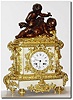 C.1830, French, Ormolu and Bronze Figural clock, a young boy with flute watching over a winged cherub at rest.