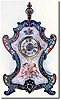 C.1880, French, Small Cloisonne Clock with porcelain panel front, two loving cherubs with a jewelry box and mirror, admiring themselves.