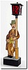 C.1960, German, "Whistling Drunk' , a carved figure leaning against a lamp post, with batteries in the base that light the lamp while he is whistling.