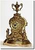 C.1910, French, ormolu on marble figural clock, two figures beside a floral tower, surmounted by an urn.