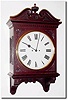 C.1890, English, 2-Fusee, Mahogany cased wall clock, in an attractive case with carved floral trim, carved base bracket, fretted and hinged side doors and a broken arch top with fluted center finial.