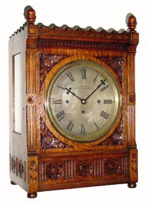 C.1890, English, 3-Fusee, 8-bell quarter chiming table clock, in oak with carved floral relief. — Antique Clocks Price Guide