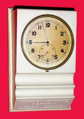 C.1950, Swiss, Battery Desk clock, 3v, in original white plastic counter top display with wooden base. — Antique Clocks Price Guide