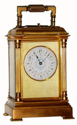 C.1900, French, Drocourt, for Tiffany and Co., brass cased carriage clock, reeded column case, time, strike and repeat, and with multi color dial. — Antique Clocks Price Guide