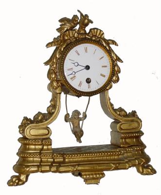 C.1890, French, Swinging Doll clock, time only, in a gilt white metal case surmounted by love birds. The movement is a typical "double escape wheel" with chaff cutter verge. The movement is signed eschappement brevete. — Antique Clocks Price Guide