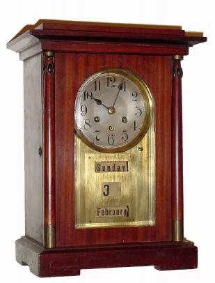 C.1910 German, mahogany automatic calendar clock, 8-day time and gong strike, case with Art Deco influence, brass dial surround and brass sleeves on the columns. — Antique Clocks Price Guide