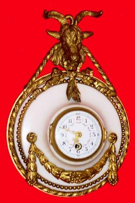 C.1900, French, boudoir timepiece, marble and ormolu, a strut case, surmounted by a ram. — Antique Clocks Price Guide