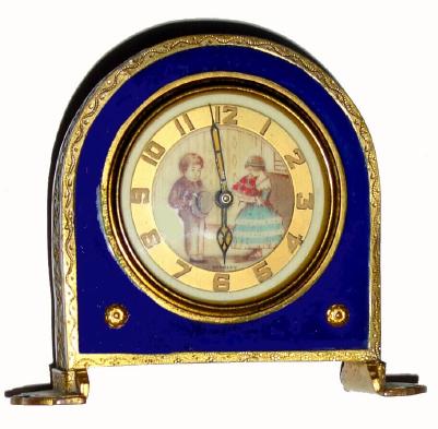 C.1925, German, Ladies Boudoir clock, with a pastel portrait of a youthful couple in courtship. The gilt brass case with cobalt blue enamel around the dial and a woven pattern of white enamel around the outer edge. — Antique Clocks Price Guide