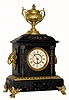 C.1880, Ansonia Clock Co., 8-day time/strike enameled iron cased mantel clock, with ram's heads on either side and a finial at the top. 