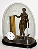 Composite group of clock parts that manage to run. A 1790 rear mount pinwheel movement with 60 pin 'scape wheel, now with associated dial, hands and pendulum rods, suspended from a gilt wood column, flanked by a wooden statue of a lady and dog with 1 broken leg, all under a period glass dome. 