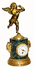 C.1880, French, Ormolu and Bronze figural clock, a variegated dark green marble base, surmounted by a winged male cherub, running with abandon. 