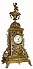 C.1890, French, Large Brass figural clock, 8-day time only, the oversize pierced case covered with vines and buds, the base with toed feet and the urn at top surmounted by a cherub. 