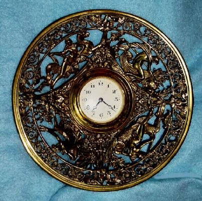 C.1920, German, Unsigned, Round Cast Brass novelty strut clock with 30 hour rear wind fit up movement. — Antique Clocks Price Guide
