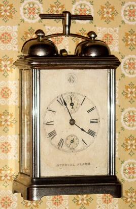 C.1900, W, L. Gilbert, INTERVAL ALARM, 1-Day, in a nickel plated case with external bells, and handle spanning the bells. — Antique Clocks Price Guide