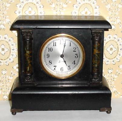 C.1915, Sessions, Bristol, Conn, Mini black mantel clock with faux marble columns to the side and cast metal capitals and feet. — Antique Clocks Price Guide