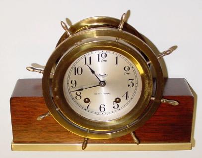 C.1930, Seth Thomas, No. 8 Mayflower, Ships bell mantel clock, ships wheel bezel, mounted to original mahogany block with brass base. — Antique Clocks Price Guide