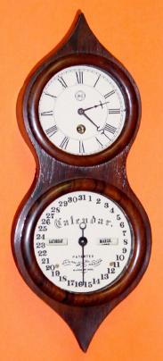 C.2000, Michael Paul, Berea, Ohio, Mini Peanut Calendar clock, No. 9 of 29, numbered on rear label and brass strap at bottom of case. — Antique Clocks Price Guide