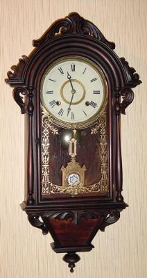 C.1875, E. N. Welch HANGING ITALIAN, 8-day time and strike, rosewood with carved accents. — Antique Clocks Price Guide