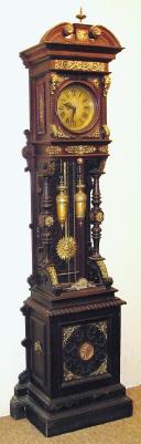 C.1890, German, LFS Uhrenfabrik, OPEN WELL HALL CLOCK, with around 32 pieces of bronze trim accenting the ebonized oak case, and with sunburst pendulum and fancy weights. — Antique Clocks Price Guide