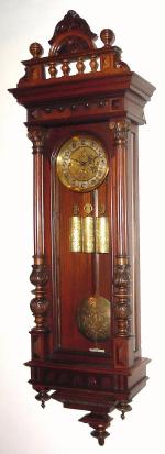 C.1885, Austrian, 3-Weight Grand Sonnerie wall clock in walnut, with carved 3/4 columns (are almost full except for where they mount to the door). — Antique Clocks Price Guide