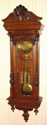 C.1885, Austrian, 3/4 Column, 3-Weight, Grand Sonnerie wall clock, walnut case with engraved weights, dial center and matching grid-iron pendulum. — Antique Clocks Price Guide