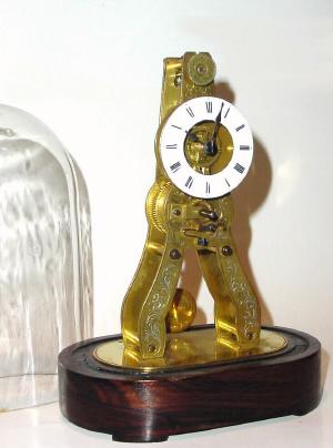 C.1851, French Skeleton Timepiece, with engraved front plate, on a wooden base, silk thread suspension. — Antique Clocks Price Guide