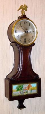 C.1920, Sessions Clock Co, Small Banjo timepiece, with 6" dial and stagecoach tablet in the bottom door, 8-day pendulum movement. — Antique Clocks Price Guide