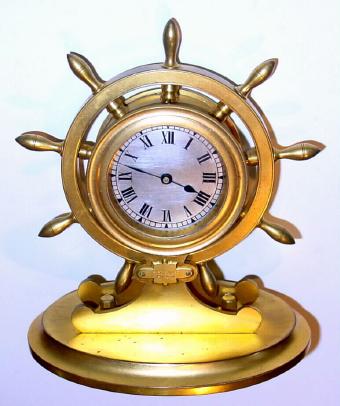 C.1920, French, for Scottish retailer, desk timepiece in the shape of a ship's wheel, jeweled lever timepiece, rear wind, with shutter for f/s adjust. — Antique Clocks Price Guide