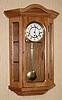 C.2000, Black Forest Clock Co, Cleveland, OH, Hermle movement, Westminster chime wall clock with display shelves, oak case.