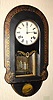 C.1875, Anglo-American Wall clock, 8-day striking movement signed E. N. Welch, the outer case of papier-m and acirc;che, painted black and with gold stenciling around the border and a painted scene at the bottom.