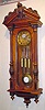 C.1880, Austrian, 3-Wt Grand Sonnerie, walnut cased wall clock with 3/4 columns and matching carved top, the dial center, pendulum and weights with matched scroll style engraving, the pendulum with grid iron accent, similarly engraved, and also with "R-A" center to bob, with steel pointer.