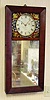 C.1825, B. Morrill, Boscawen, NH, mirror front wall clock with beveled frame, 8-day time and strike, the case back relieved to accept the movement and still present thin silhouette.