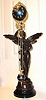 C.1895 Ansonia Clock Co., GLORIA SWING, clock, patinated spelter statue of goddess Gloria, with a harp in her left hand, holding her right arm aloft and supporting the ball swing clock that moves with no apparent impulse.