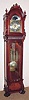 C.1995, American Hall Clock "THE MAJESTIC", 3-weight, cable drive, 8-day, playing your choice of 3 tunes on 9 rods: Whittington, St. Michaels or Westminster, with large lyre/grid iron pendulum, in a mahogany case with burled and carved accents.