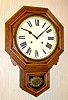 C.1915, Ansonia Clock Co, Short Drop Octagon, in oak, with 8- day time and strike movement.