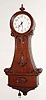 C.1904, American 110v Electric Banjo, in a nicely carved mahogany case and with porcelain dial.