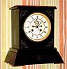 C.1905, French, Egyptian Revival, black marble mantel clock, incised with winged insect on base.