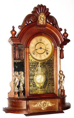 C.1880, Ansonia Clock Co., TRIUMPH, in walnut, 8-day time and strike and with restorations. — Antique Clocks Price Guide