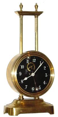 C.1921 English Gravity timepiece, the movement being driven by its own weight, and raised each day along a ratcheted upright and with exposed escapement and compound bar-bell pendulum. — Antique Clocks Price Guide