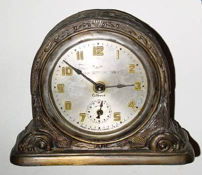 C.1920, Gilbert KENTON bronzed pot metal alarm clock with ADVERTISING. — Antique Clocks Price Guide