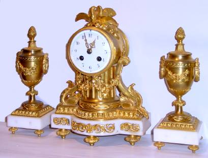 C.1900, French, Samuel Marti, for J. E. Caldwell, Philada, Love Birds, ormolu and white marble mantel clock with original matching side urns, jeweled lever movement. — Antique Clocks Price Guide