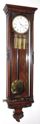 C.1845, Austrian, 3-Wt Grand Sonnerie wall clock, with one piece porcelain dial, cast "Pie Crust" bezel, and rosewood case with edge stringing and molded applique. — Antique Clocks Price Guide