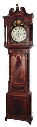 C.1830, English, W. B. Cornforth, Macclesfield, 8-Day, 2-weight, moon dial tall clock, painted, black mask dial with raised, convex center, and flowers in the corners and sea shells in the hemispheres. — Antique Clocks Price Guide