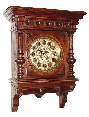 C.1890, Austrian or South German, Large Walnut wall clock, enclosed pendulum, with fancy gilt/silver dial and tulip hands. — Antique Clocks Price Guide