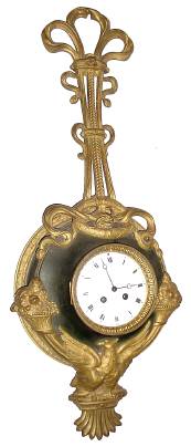 C.1890 French, 8-day time/strike rococco cartel wall clock, a Phoenix with outstretched wings that turn into horns of plenty bursting with fruits, and hanging from a lyre of ormolu ribbons. — Antique Clocks Price Guide