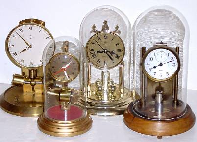 A Lot of Four Clocks: 1) Barr Mfg, Battery timepiece and glass dome, with incorrect pendulum; — Antique Clocks Price Guide