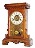 C.1900, Waterbury, VICTOR, Mini Kitchen clock, incised fruit wood, 30 hour time with strike and outboard alarm.