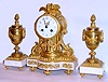 C.1900, French, Samuel Marti, for J. E. Caldwell, Philada, Love Birds, ormolu and white marble mantel clock with original matching side urns, jeweled lever movement.